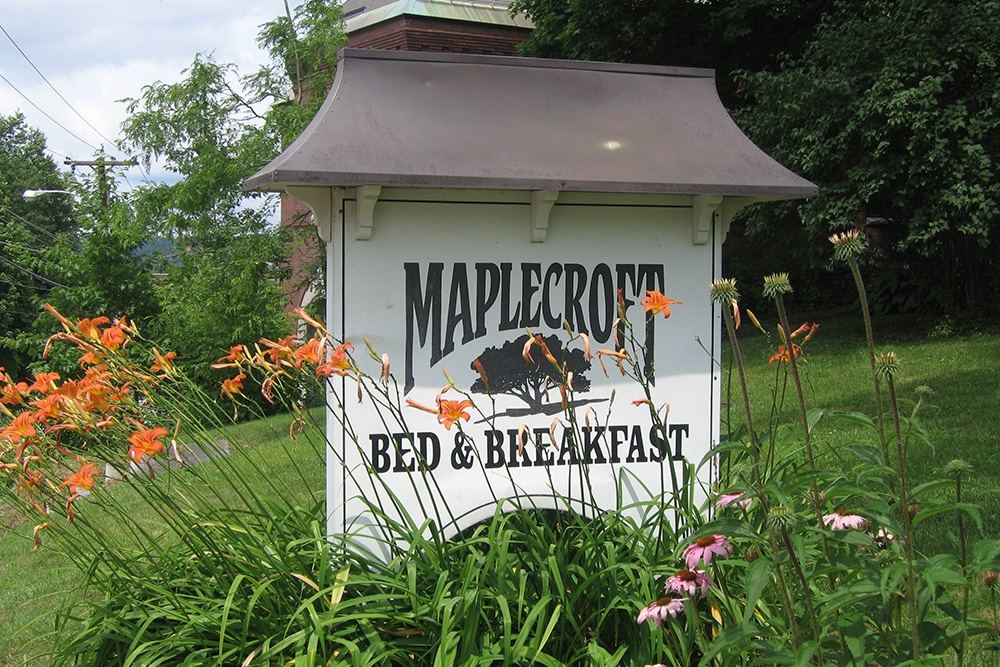 Maplecroft sign surrounded by garden flowers